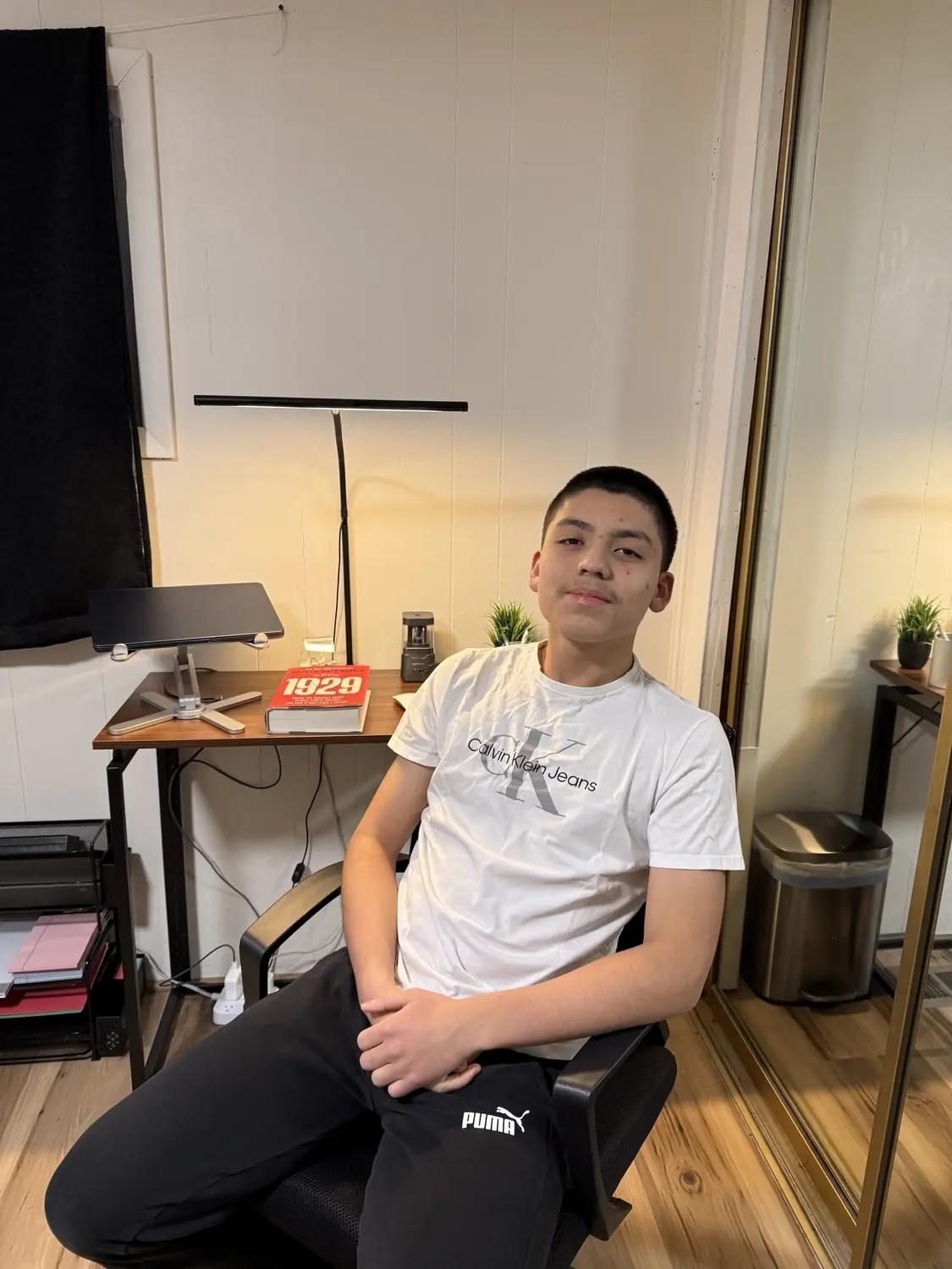 Adriel leaning back in his desk chair at home, same shirt, January 2026
